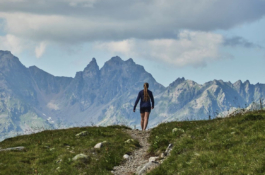 women hiking in the mountains. walking away from the camera with mountains in the background Ross Woodhall - Action & Lifestyle Photography