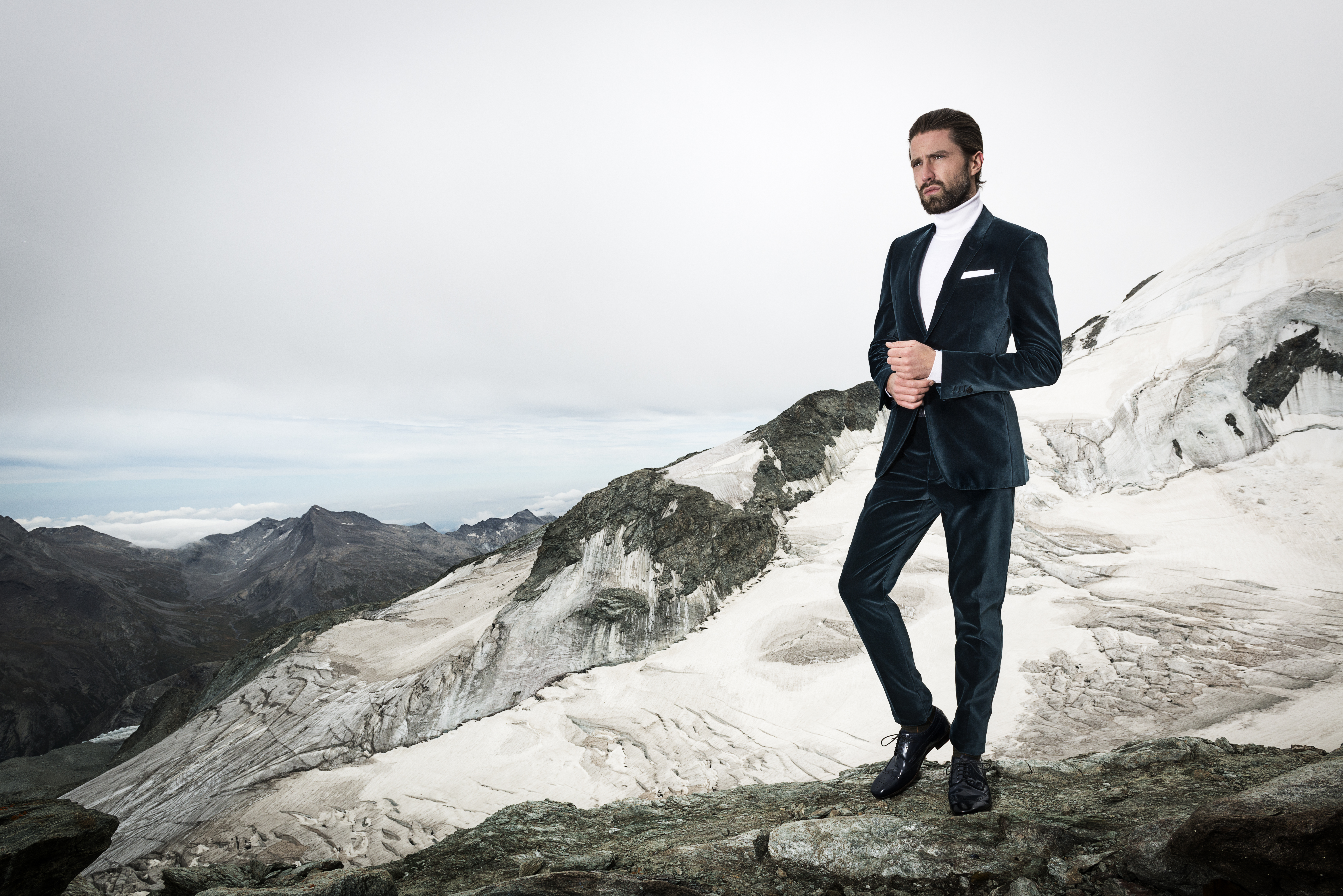 man standing on glacier in a tuxedo Ross Woodhall - Action & Lifestyle Photography