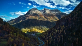 Autumnal scene of a high Alpine road with a mountain in the background Ross Woodhall - Action & Lifestyle Photography
