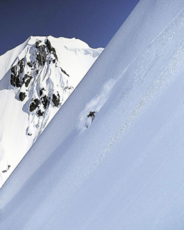 Lone skier, skiing off piste on a steep mountain Ross Woodhall - Action & Lifestyle Photography